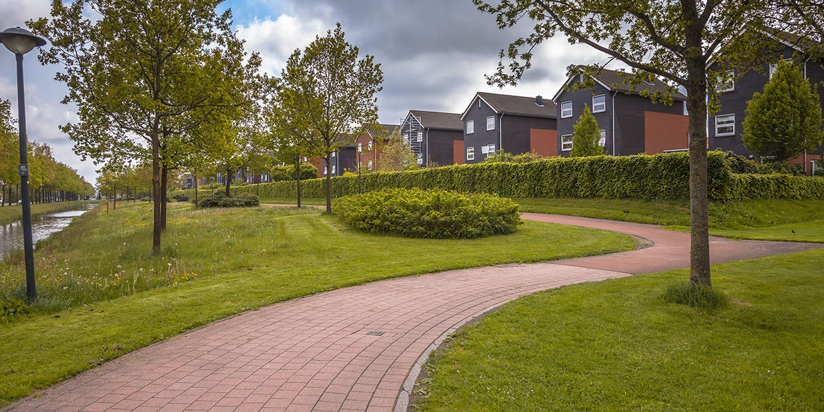 Winding brick path through a park in a residential townhouse complex