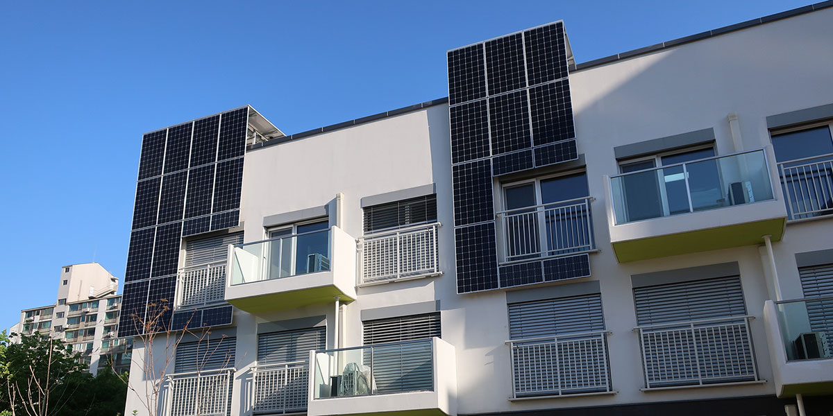 Solar panels on the exterior of an apartment building